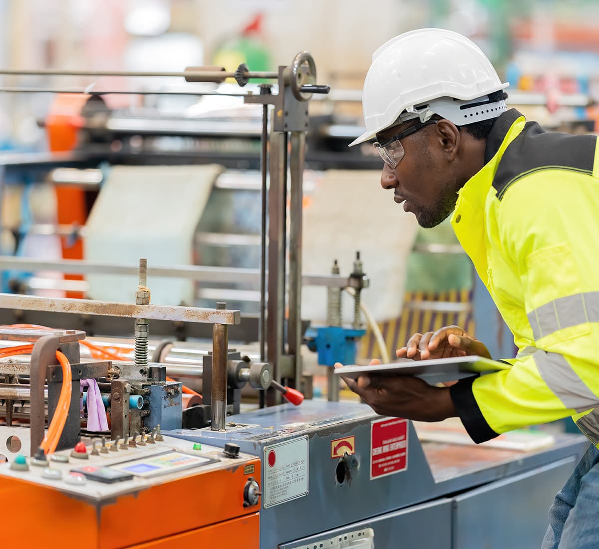 Man inspecting equipment on manufacturing floor