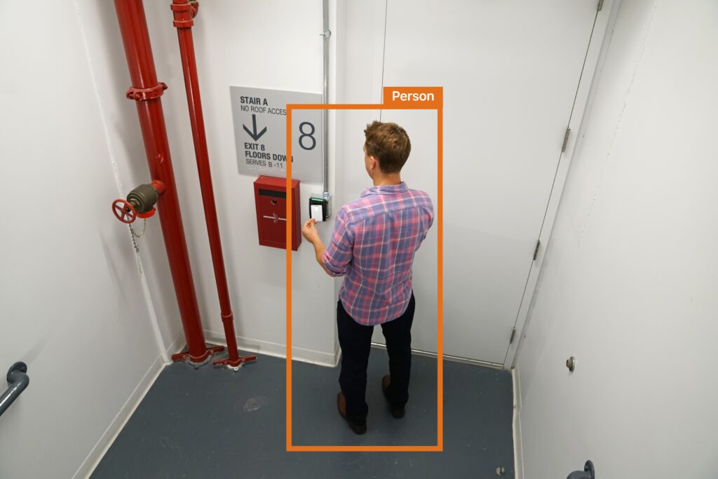 Man using key card to badge into building
