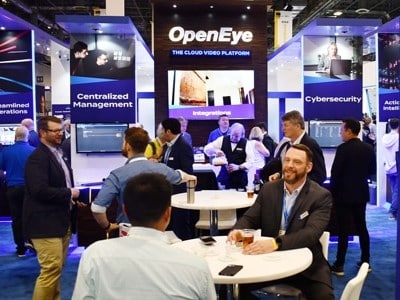A group of people gathered on an exhibition floor at a trade show