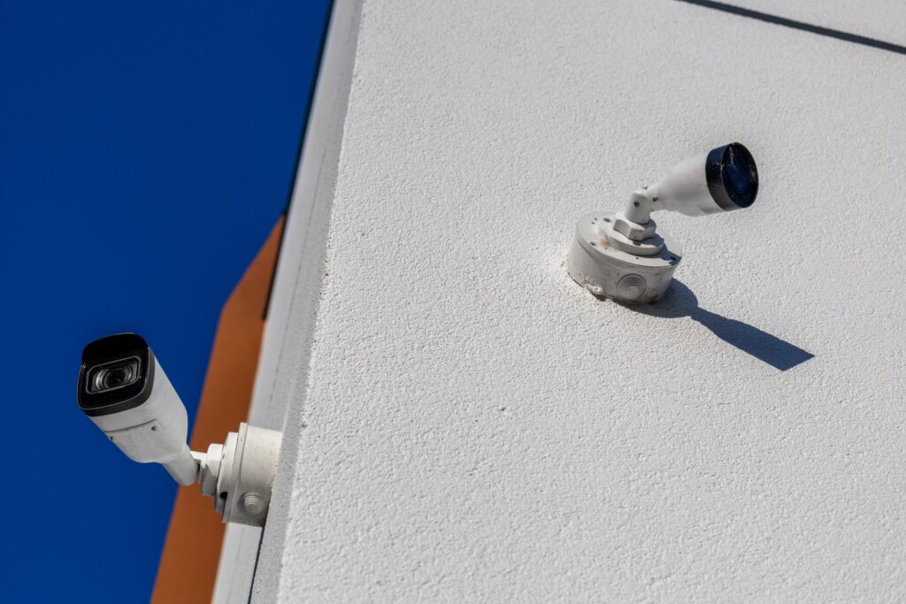 Two surveillance cameras installed on a building's exterior