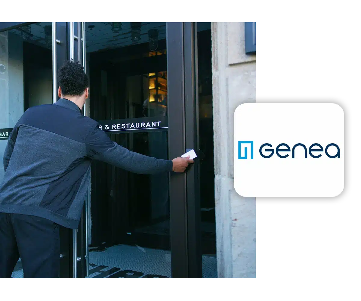 A man stands at the entrance of a restaurant, using a key card on an access control panel.