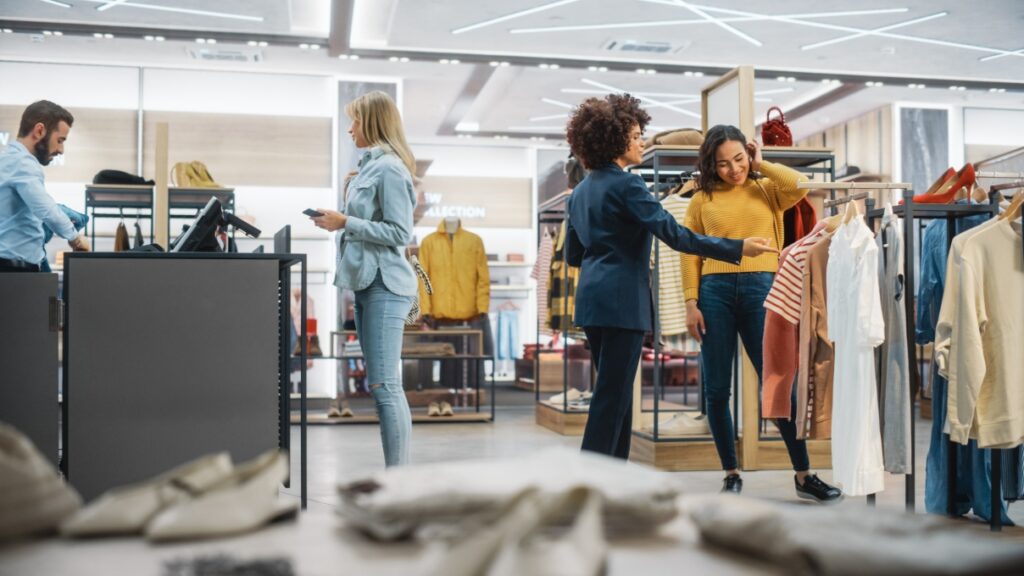 Individuals in a retail setting shopping or purchasing merchandise.