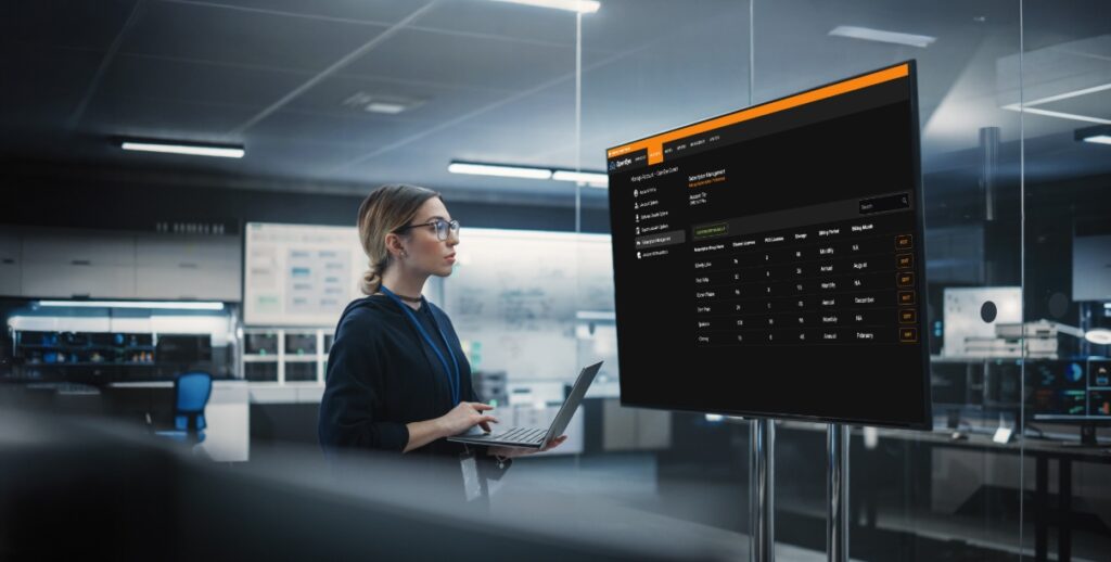 Woman in office staring at a screen displaying OpenEye Web Services.