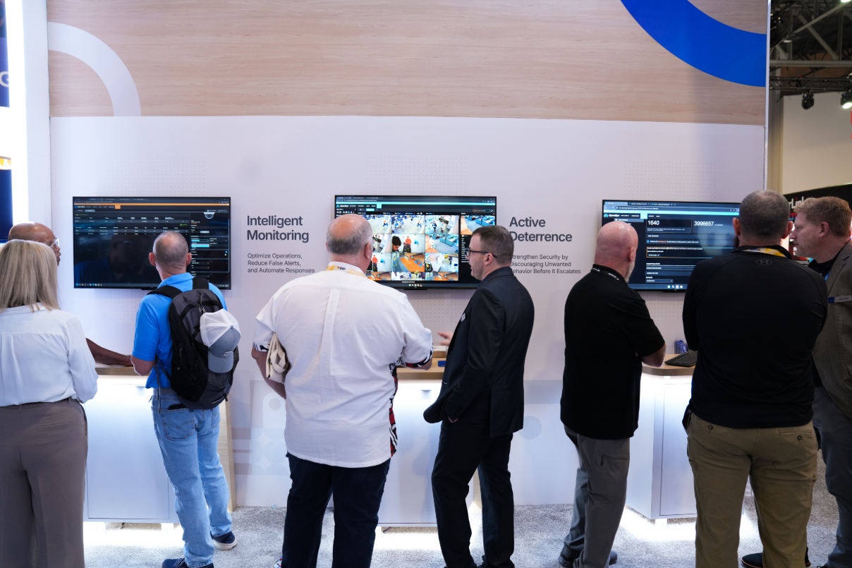 Booth attendees receive demonstrations of OpenEye Web Services' (OWS) AI-powered cloud capabilities.