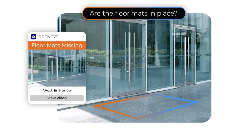 AI Visual Check in OpenEye Web Services (OWS) showing a prompt bar over a scene depicting an outdoor entrance that reads, "Are the floor mats in place?" with an alert on the left side of the scene that reads "OPENEYE. Floor Mats Missing. West Entrance. View Video."