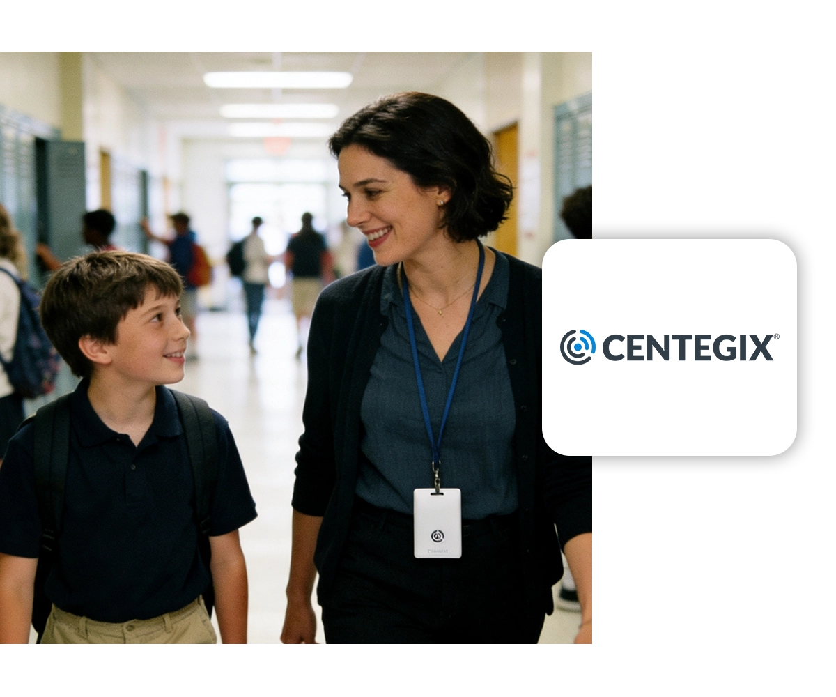A schoolteacher and student walk side by side in a school hallway with the CENTEGIX logo displayed on the right side of the image.